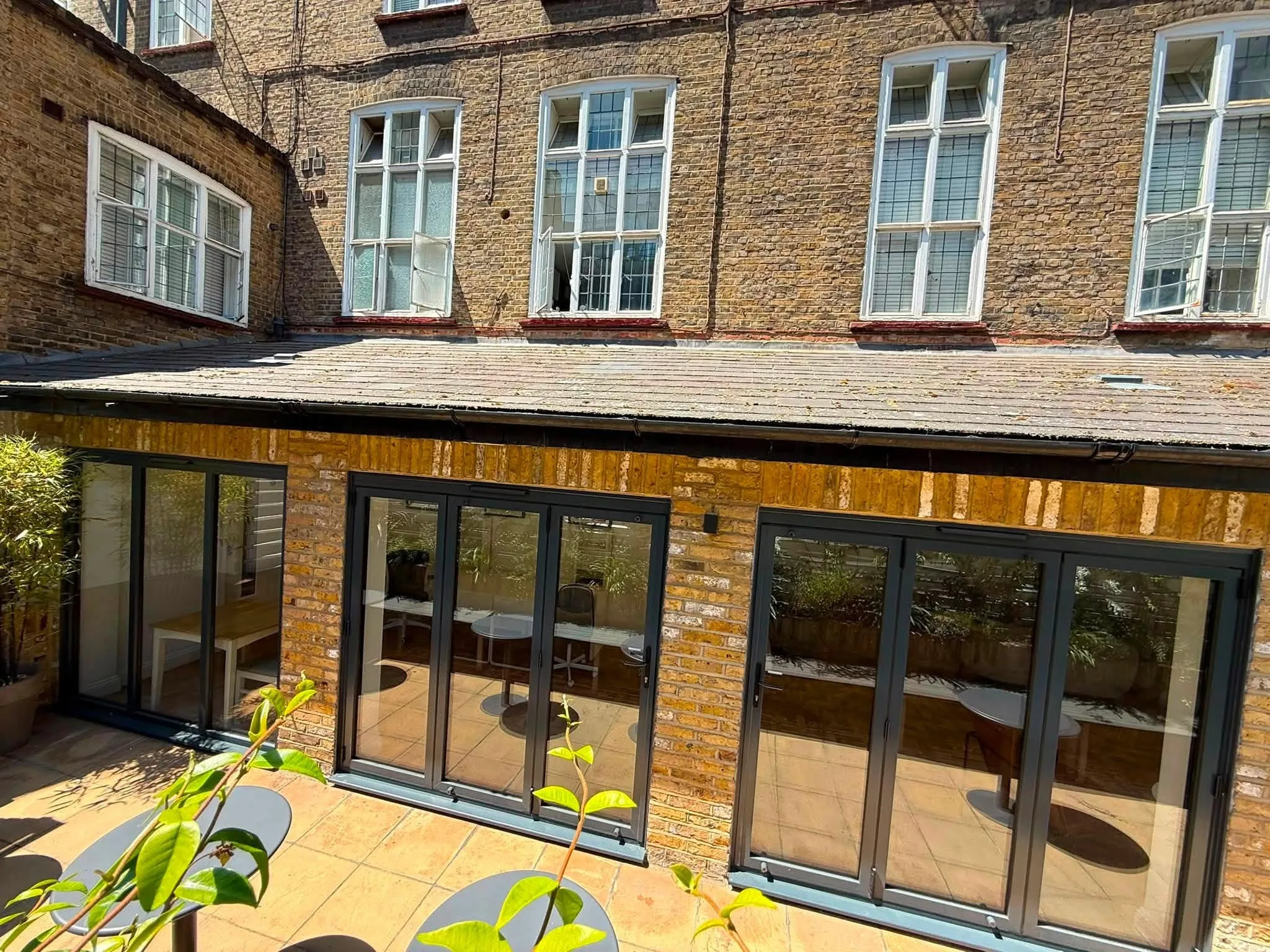 Aluminium bifold doors across the rear of an orangery extension