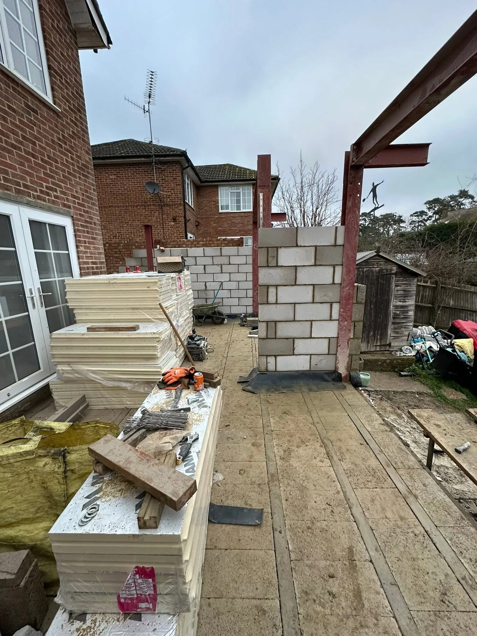 Blockwork garden wall being built alongside a new patio