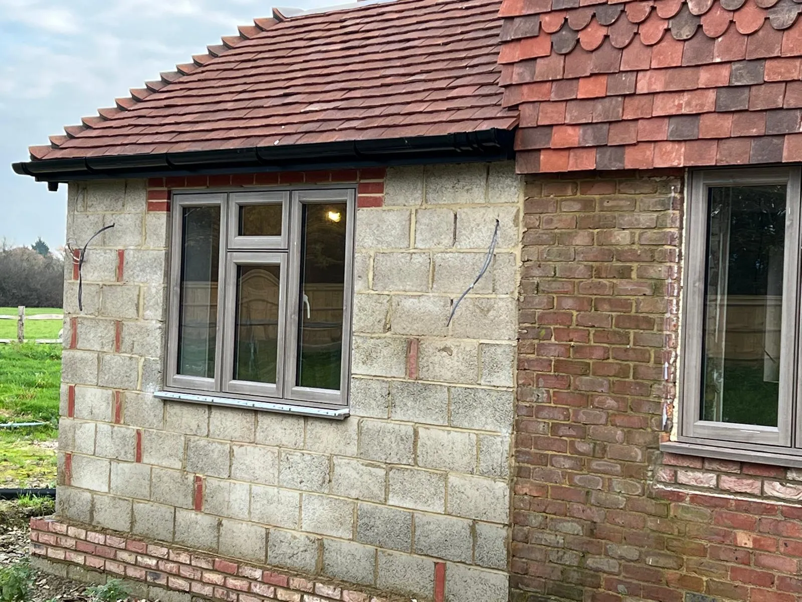 White casement windows fitted to a stone garden room