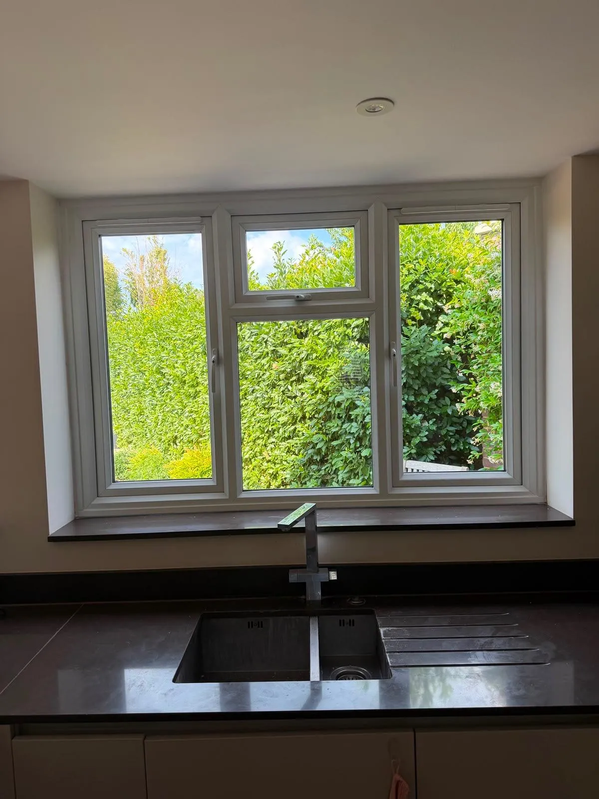 Inward-facing view of replacement windows above a kitchen worktop