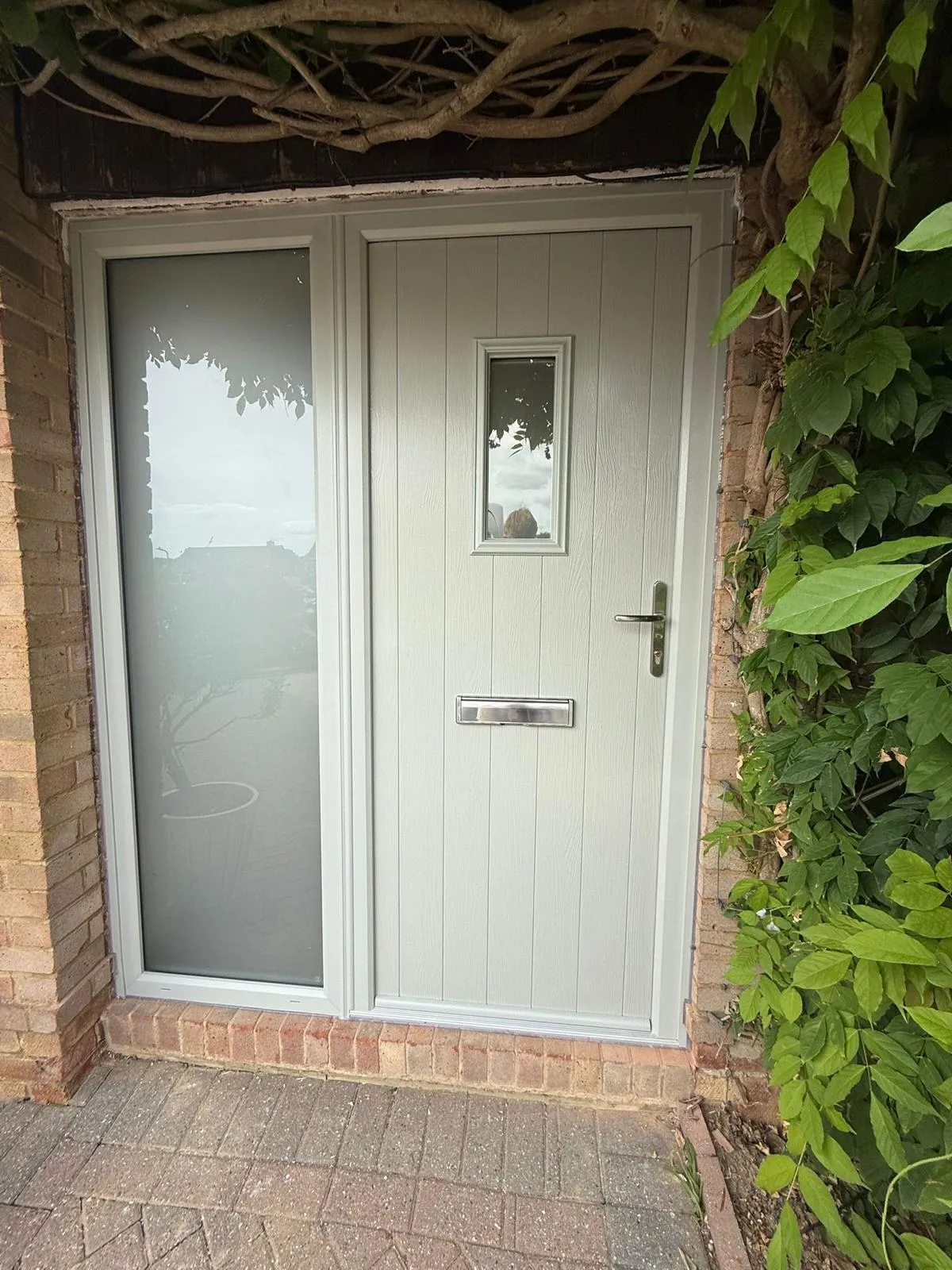 Cream composite front door with a glazed side panel