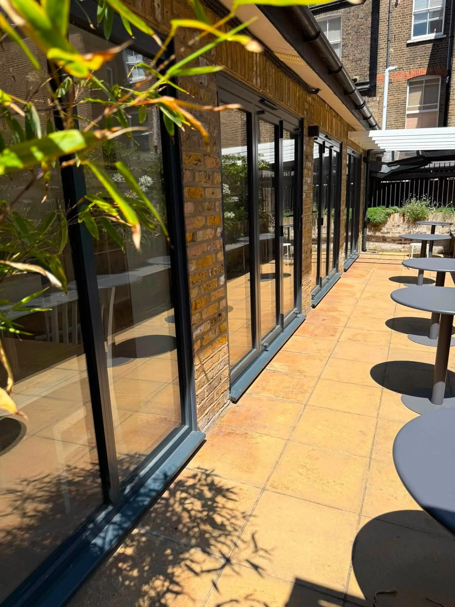 Glazed veranda running along the back of a brick house