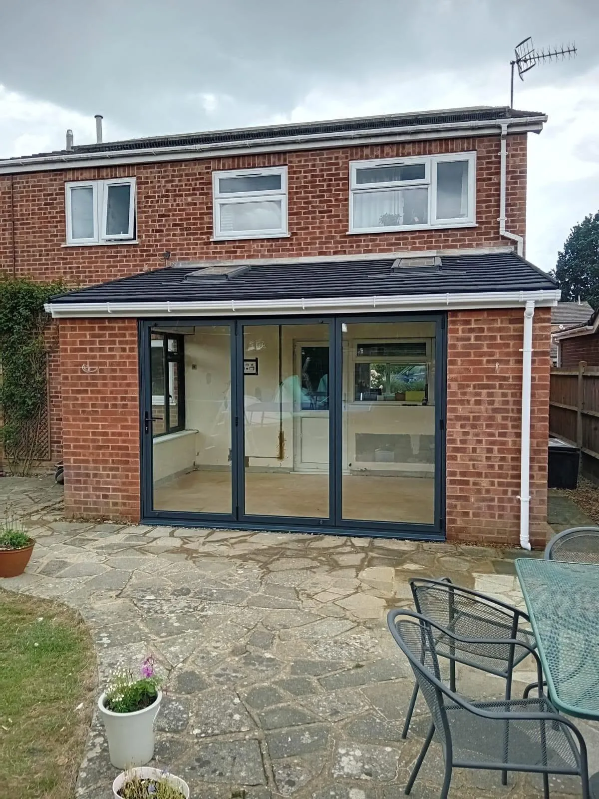 Grey framed extension with bifold doors and a flat roof