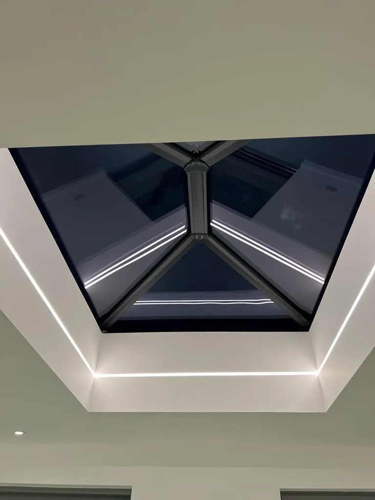Dark framed roof lantern seen from inside a room