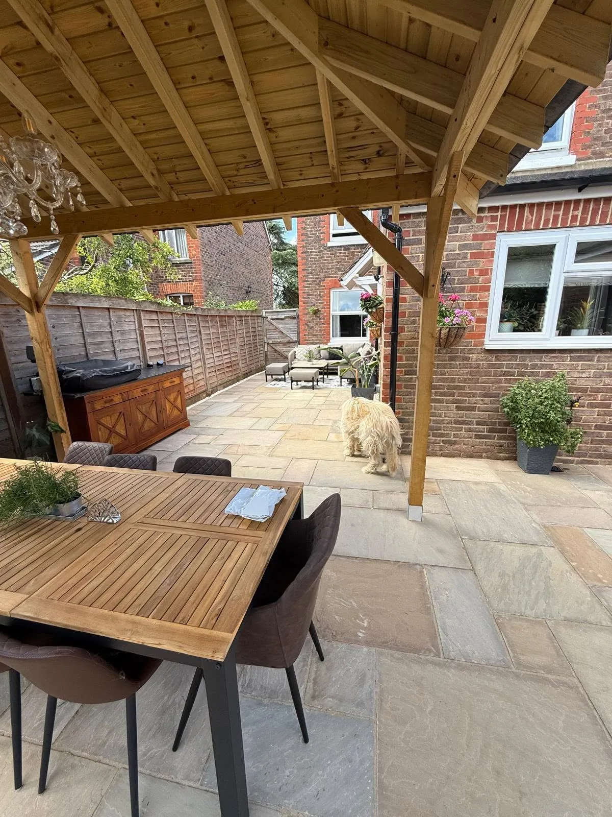 View from under the timber pergola, along the sandstone patio to the house