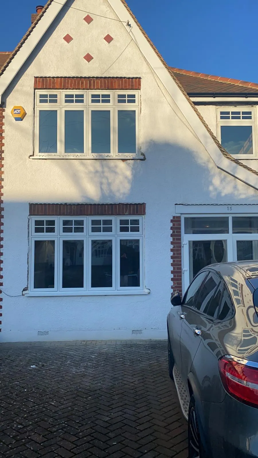 Traditional multi-pane windows on a rendered period home