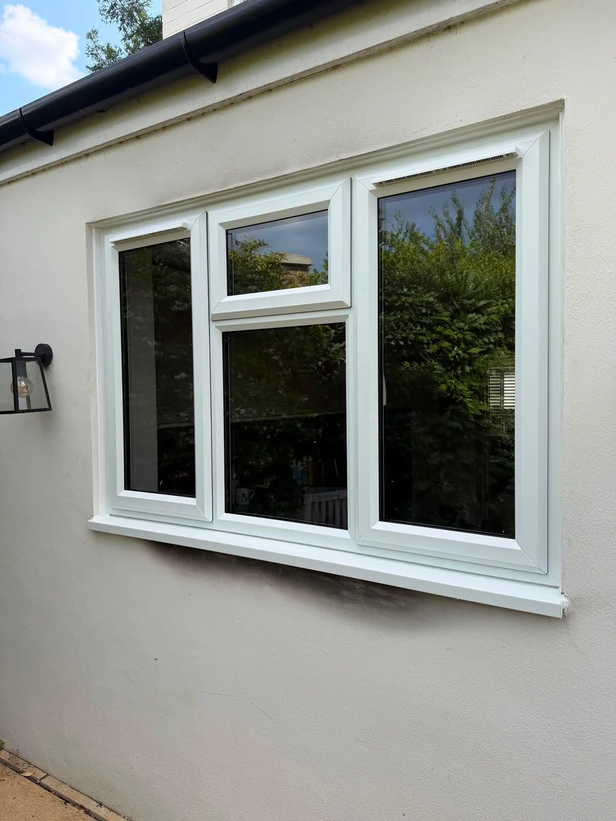White uPVC casement windows fitted to a rendered house