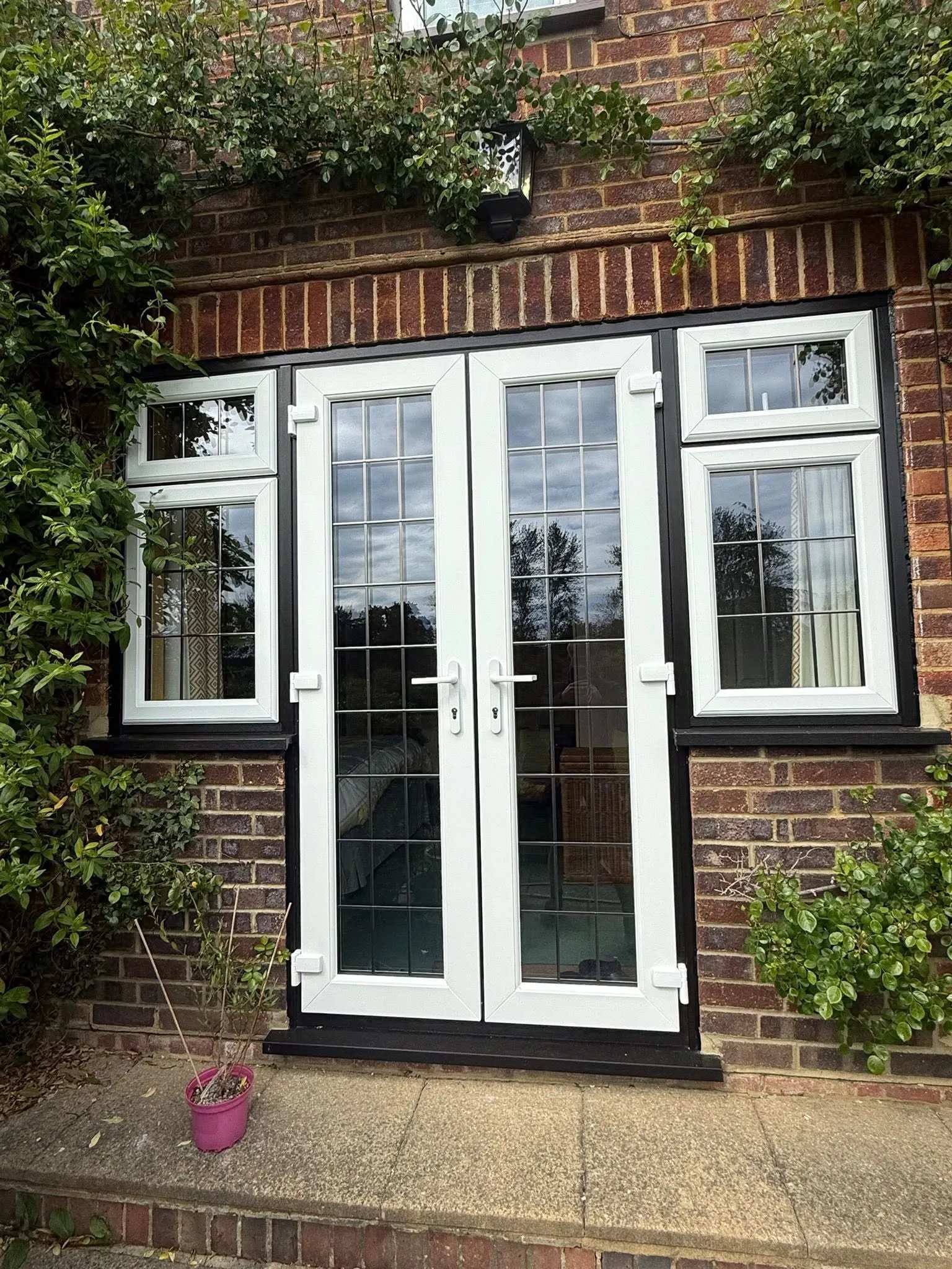 White uPVC French doors opening onto a garden in Surrey