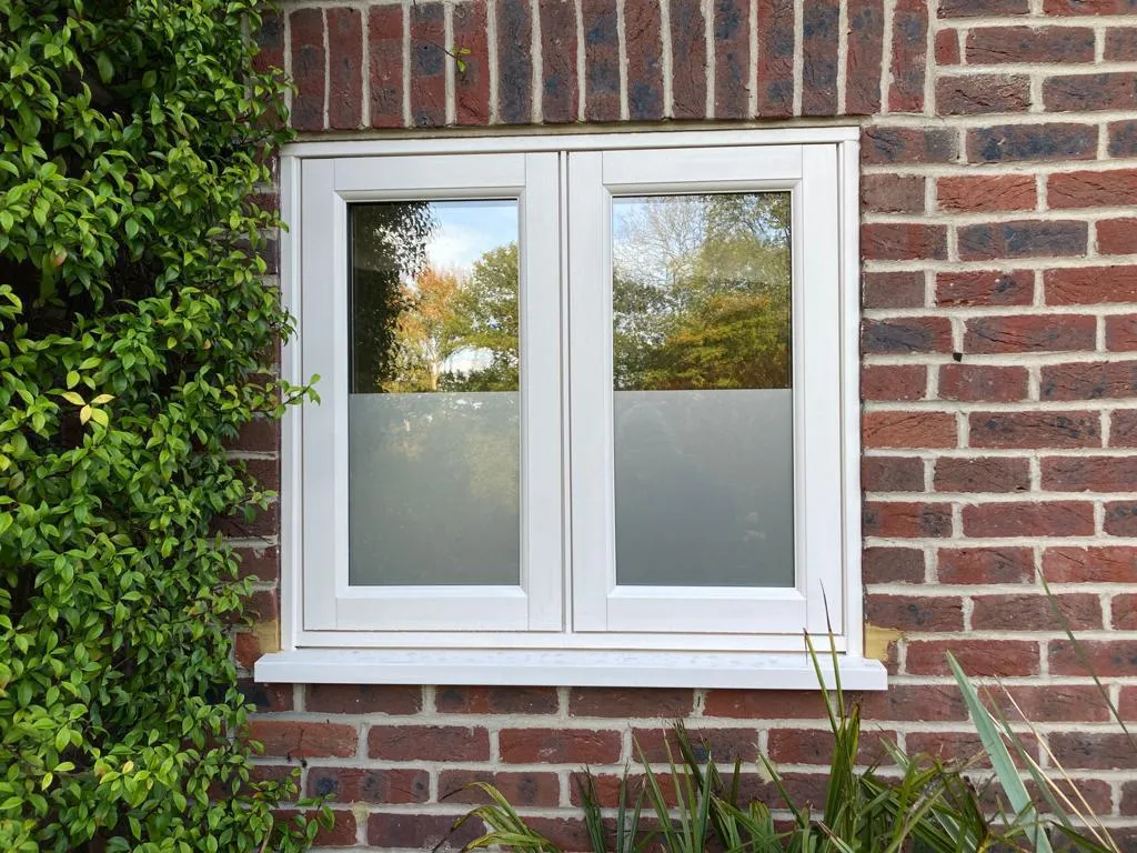 Replacement double glazed window with obscure glass in a brick wall